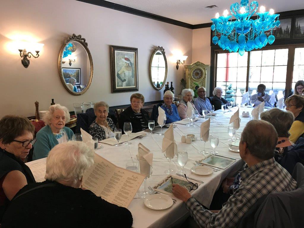 Seniors sitting around a dining table